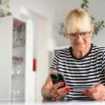 senior woman buying online with credit card