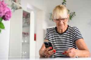senior woman buying online with credit card