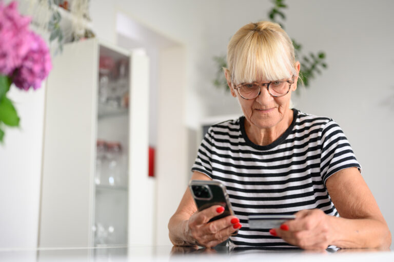 senior woman buying online with credit card
